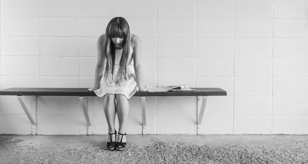 Worried Girl Waiting on a Bench