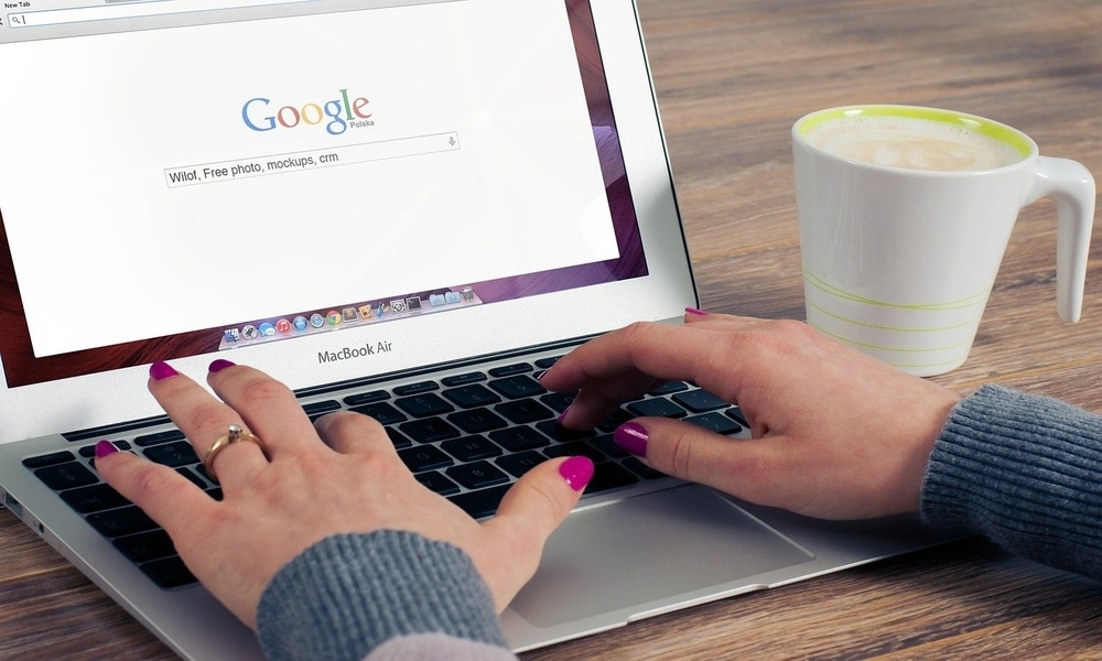 A Person Searching Google on Laptop